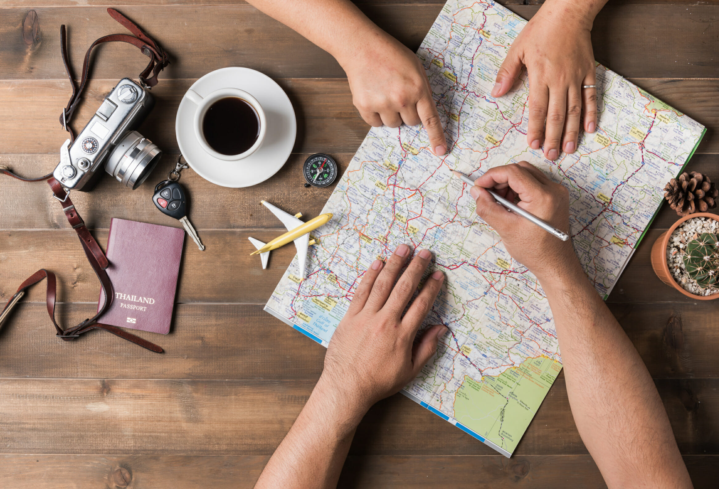 Young couple planning vacation trip with map. Top view