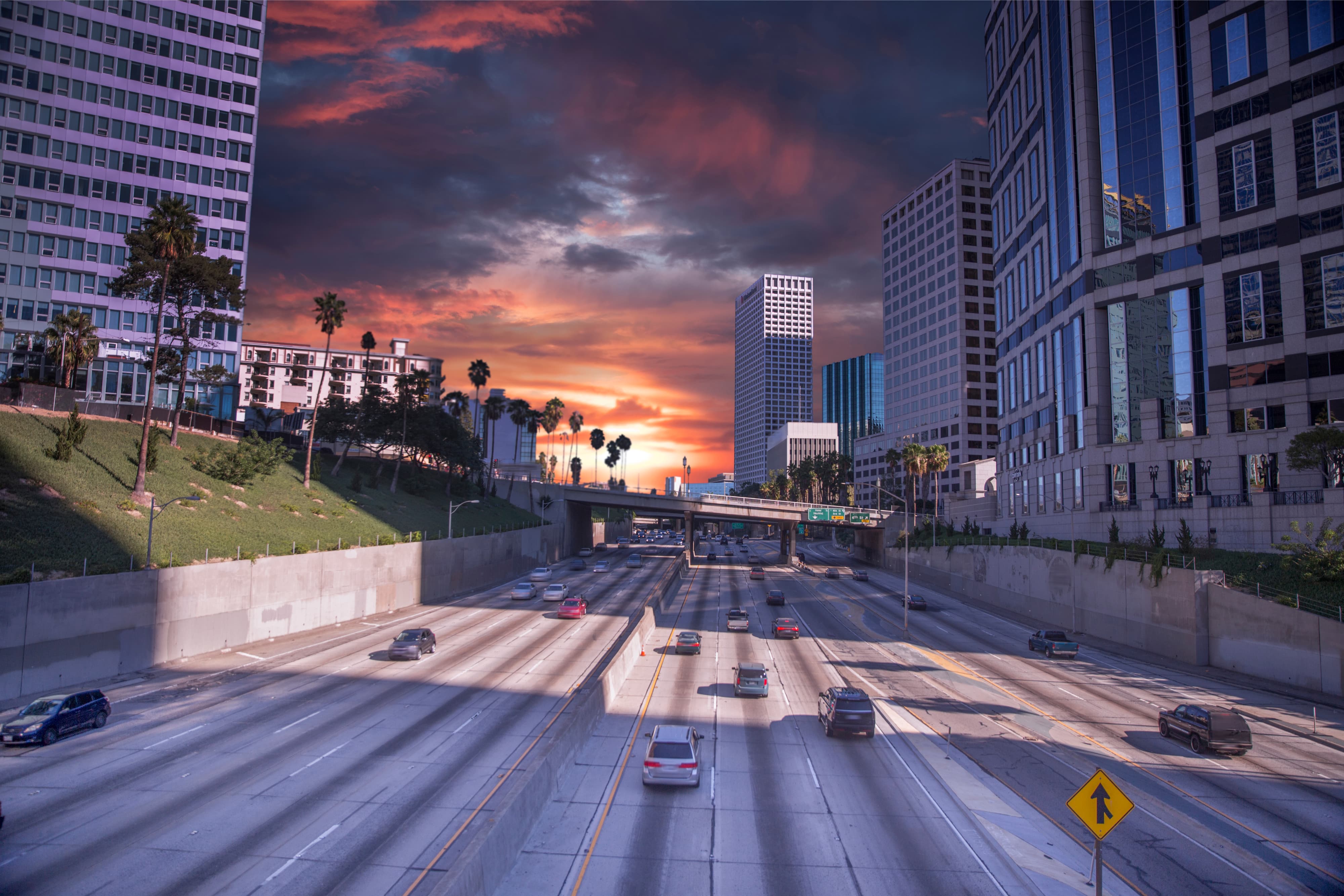 Cars driving on a freeway in Los Angeles during sunset