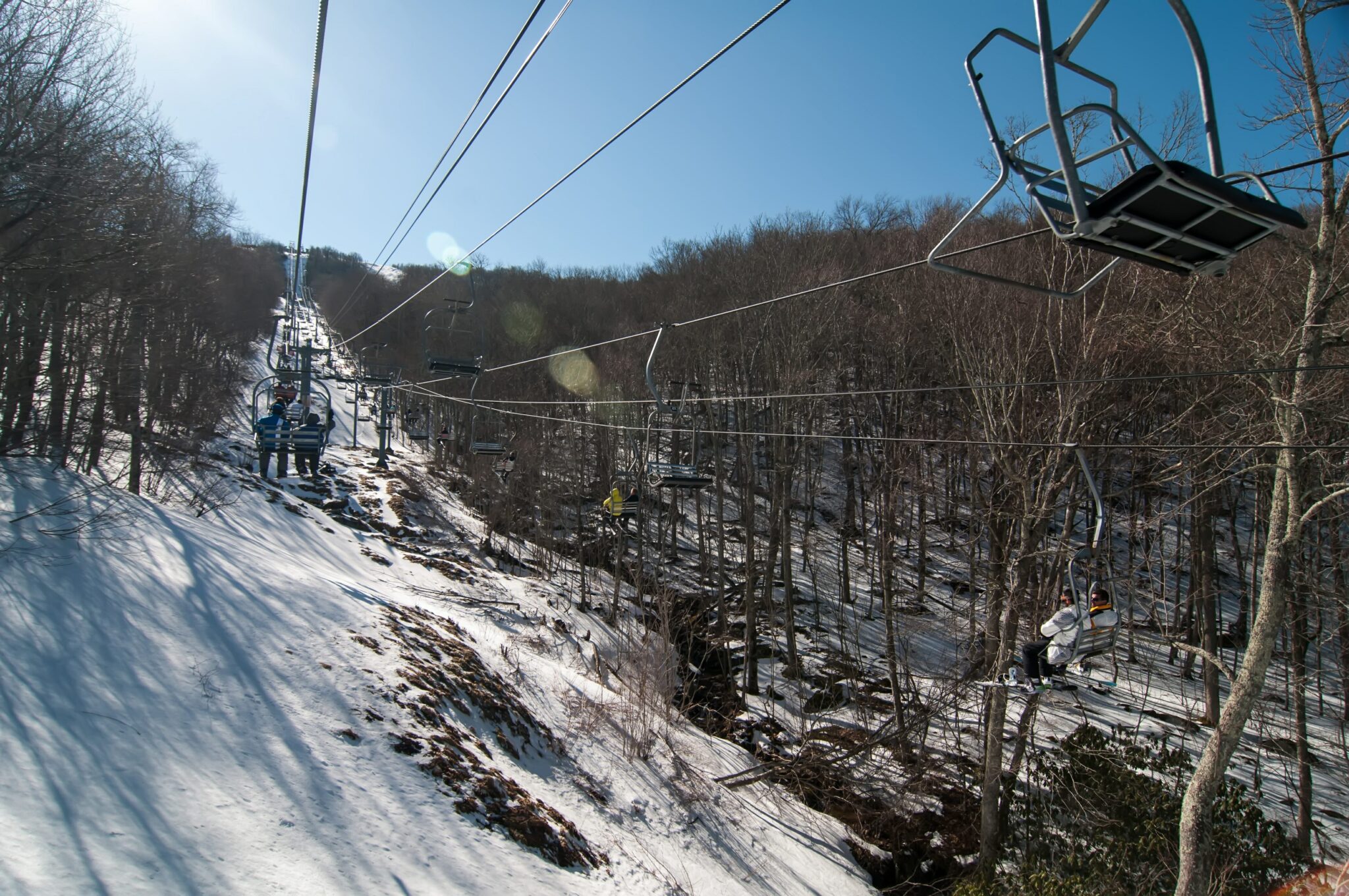 A chairlift gracefully ascends a picturesque mountain, providing access to thrilling ski slopes amid a winter wonderland