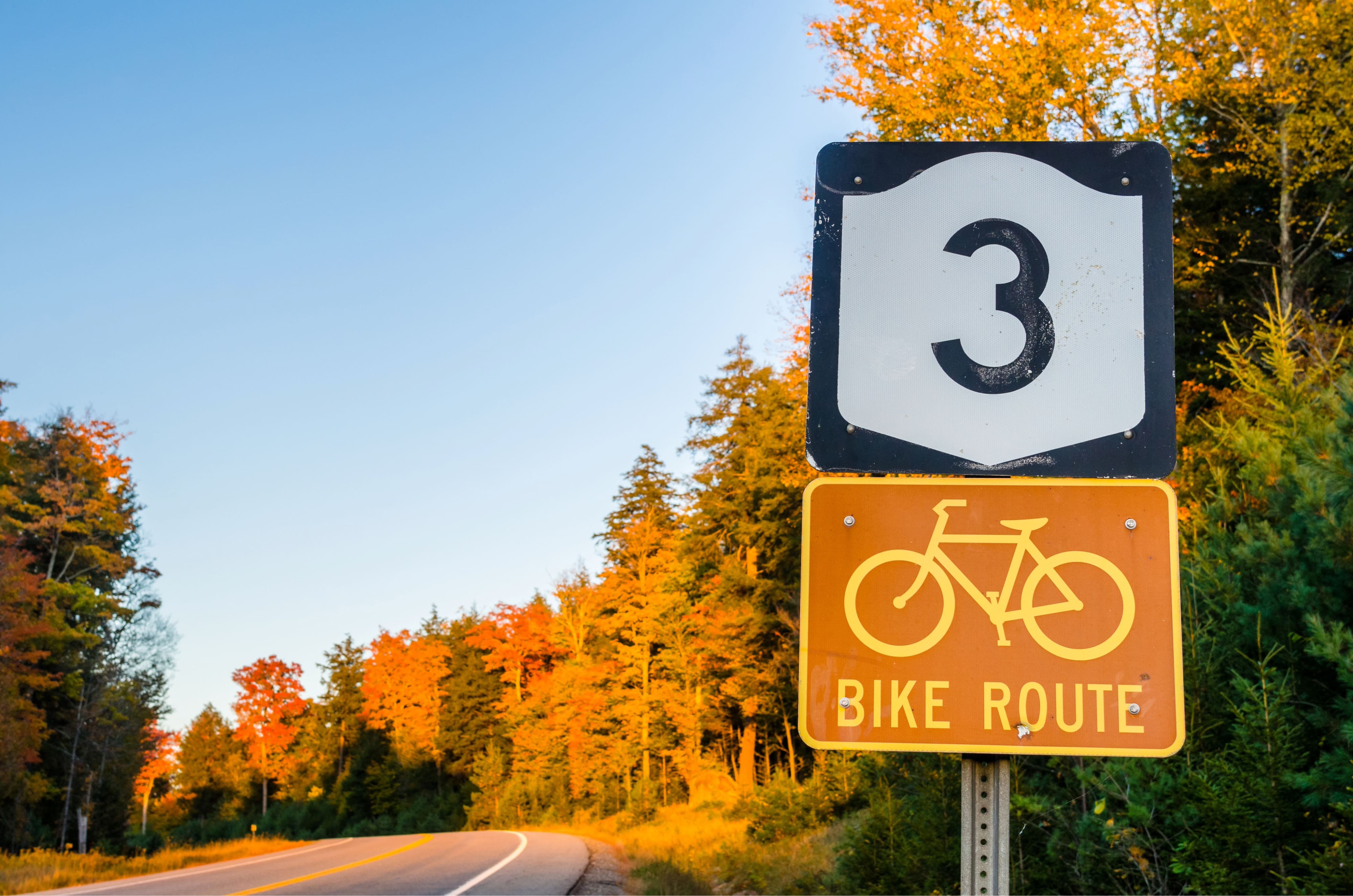 Bike Route Sign along a Highway in the Adirondacks, NY, at Sunset