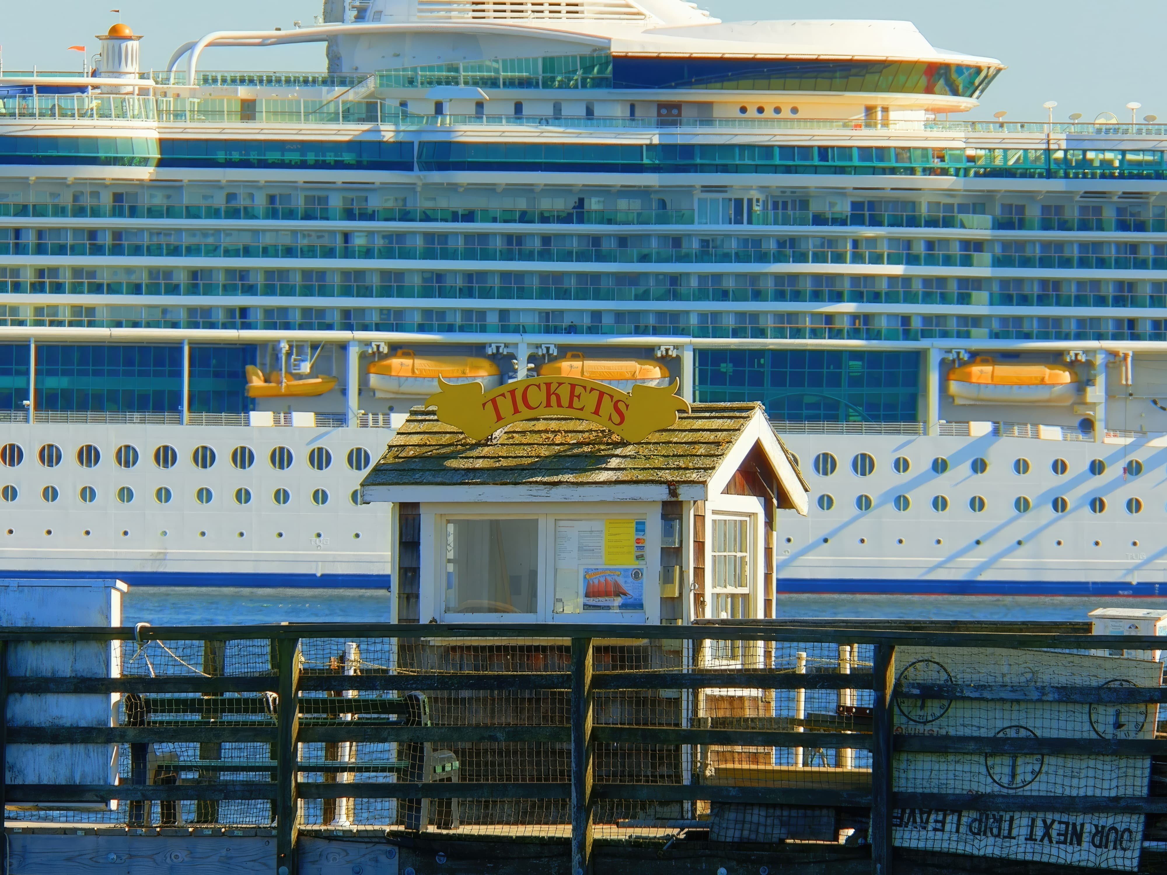 Cruise ship approaching pier with ticket booth